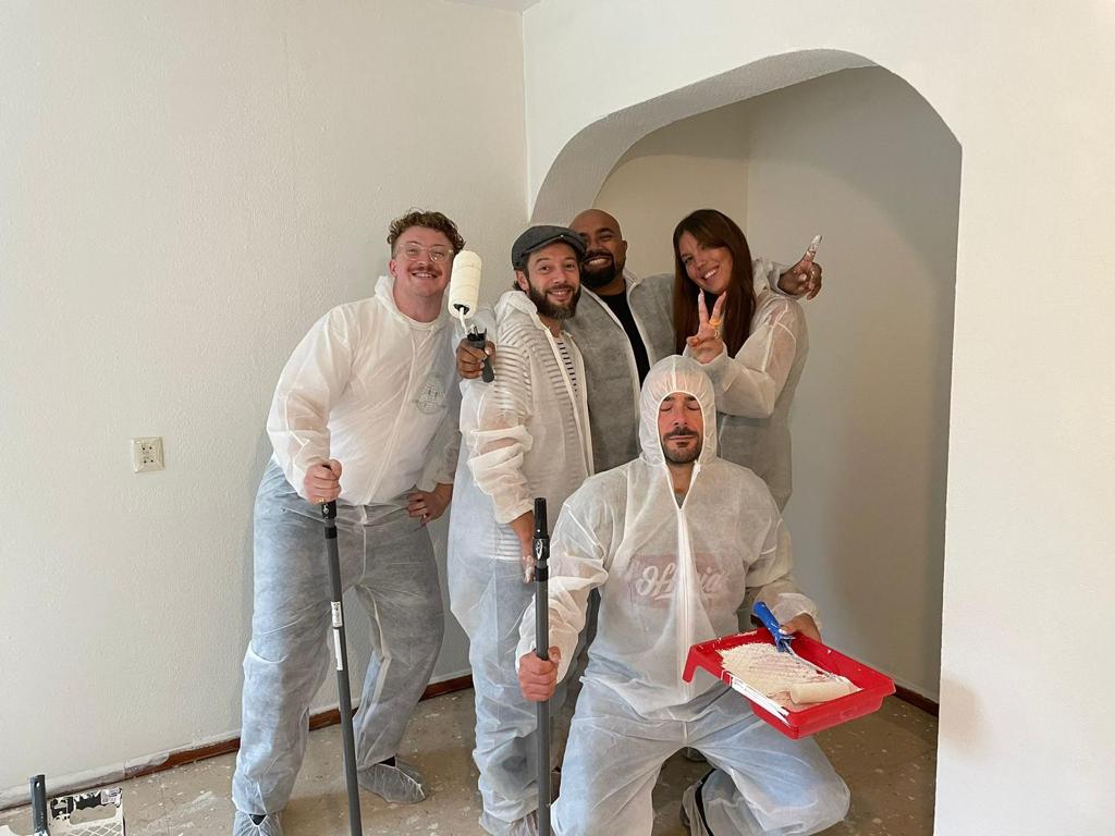 Company volunteering for painting house for former homeless