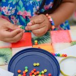 Picture of girl beading a bracelet